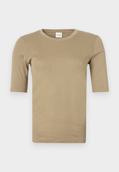 T-shirt bege de manga curta com decote redondo, confeccionada em um tecido macio e liso, com costuras mínimas e um corte ajustado.