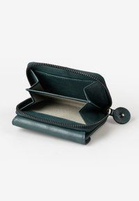 Teal leather wallet with zipper, featuring two compartments and a textured interior. Includes a snap closure on the side.