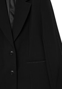 Blazer nero con una texture liscia, rever a punta, due bottoni e una tasca frontale con un dettaglio di cucitura bianca a contrasto.