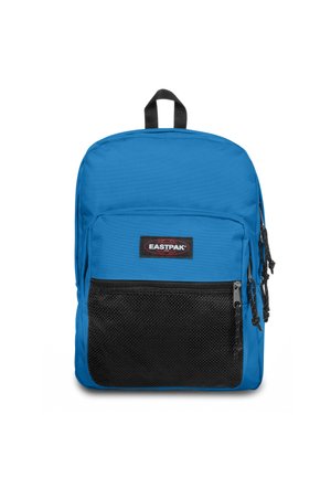 Mochila de tela azul con un bolsillo frontal de malla negra, cierre de cremallera y un asa en la parte superior. Incluye el logo de la marca y correas de hombro ajustables.