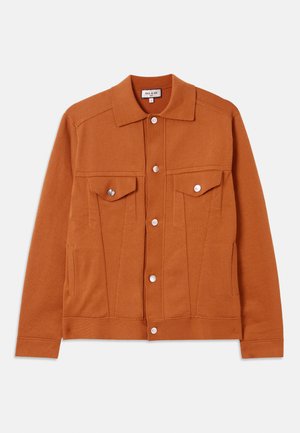 Rust-colored jacket with a button front, two chest pockets, and a pointed collar. Made of a textured fabric with visible seams.