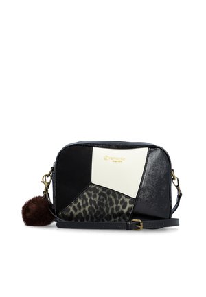Black and white patchwork crossbody bag with leopard print panel and brown pom-pom keychain attached on the side.