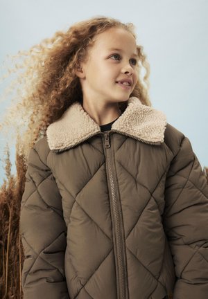 Giacca trapuntata marrone con colletto in shearling beige, dotata di una zip frontale e una finitura testurizzata. Adatta per il clima freddo.