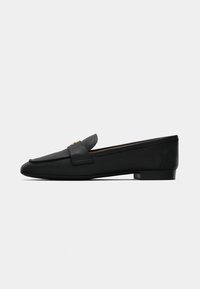 Black leather loafers with a rounded toe, flat sole, and a decorative gold hardware detail on the vamp. Smooth texture and simple design.