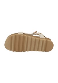 Beige sandal bottom view, featuring a textured, ridged rubber sole with braided strap accents and a flat, open design.