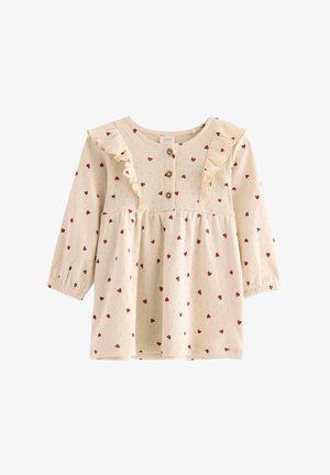 Langærmet cremefarvet kjole med rødt hjerte-mønster, med rynket halsudskæring, knaplukning foran og elastiske manchetter. Blød tekstur.