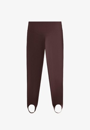 Mörkbruna åtsittande leggings med hög midja och fotremmar designade för att hålla tyget på plats under rörelse eller träning.