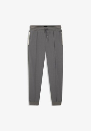Graue Jogginghose mit Kordelzugbund, zwei Seitentaschen und kontrastierenden Akzentstreifen an den Seiten. Weiche Stofftextur.