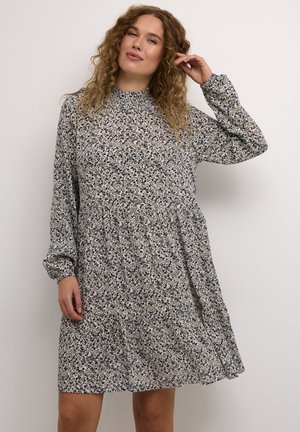 Langärmliges Kleid mit hohem Kragen, das ein florales Muster in Marineblau und Creme präsentiert. Ausgestellter Rock, leichter Stoff mit leichtem Textur.