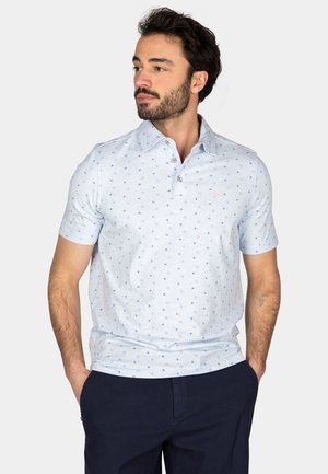 Lichtblauwe polo met korte mouwen, voorzien van een stippenpatroon en een drie-knopen placket. Zachte stof met een casual pasvorm.