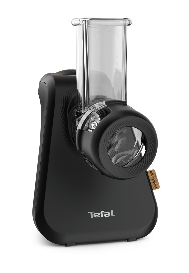 Râpe électrique Tefal en plastique noir avec un tube d'alimentation transparent et un disque de râpage circulaire. Équipée d'une étiquette éco-respect brun.