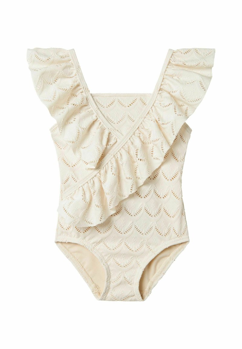 Kreminės spalvos maudymosi kostiumėlis su raukšlėtu iškirpimu, papuoštas lapų raštu ir tekstūruotu audiniu. Klasikinio vieno gabalo dizainas.