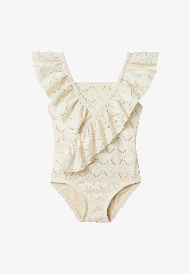 Kreminės spalvos maudymosi kostiumėlis su raukšlėtu iškirpimu, papuoštas lapų raštu ir tekstūruotu audiniu. Klasikinio vieno gabalo dizainas.