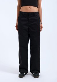 Black wide-leg pants made from a cotton blend fabric, featuring a mid-rise waist, straight cut, and classic five-pocket design.