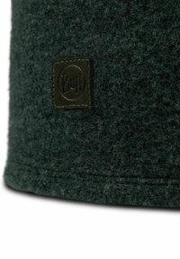 Green felt beanie with a textured surface. Features a small, rectangular olive green logo patch stitched on the side.