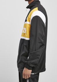 Starter Cortaviento - black