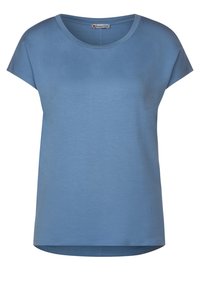 Sininen lyhythihainen t-paita, joka on valmistettu pehmeästä kankaasta. Ominaisuuksiin kuuluu pyöreä pääntie ja löysä istuvuus hieman pidemmällä takapäällä.