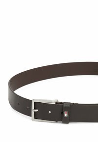 Brown leather belt featuring a rectangular silver buckle and multiple holes for adjustment. A small logo accent near the buckle.