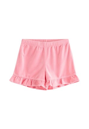 Smilende ung pige med blond hår i to hestehaler iført en pink lynlåshættetrøje, flæse-shorts, skjorte med fugleprint og blomstrede slip-on sko.