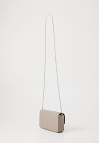 Beige textured crossbody bag with a gold chain strap, rectangular shape, and a smooth finish. Features a fold-over flap design.