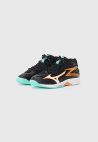 Black athletic shoes with orange and white accents, featuring a textured upper, turquoise laces, and a mint green rubber sole.