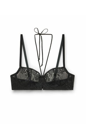 Sort blonde-bh med gennemsigtige skåle, justerbare stropper og dekorativ sløjfe bagpå. Blomsterdesign tilføjer teksturel detalje.