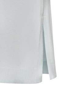 Maglione in maglia azzurro chiaro con una texture a costine, fessure laterali e un silhouette rilassata. Il materiale sembra morbido e leggermente elasticizzato.