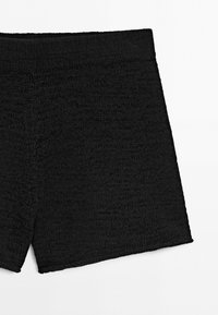 Black textured high-waisted shorts with a wide elastic waistband, shown on a plain white background, no visible branding or decoration.