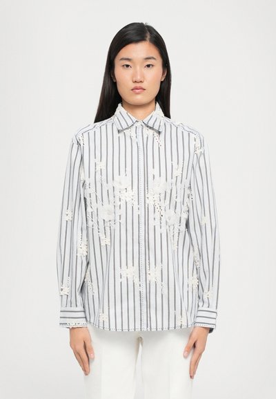 Striped shirt with white and black lines, featuring floral embroidery and a button-up design. Made from lightweight fabric, long-sleeved.