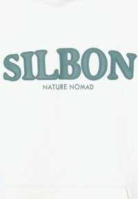 Logo SILBON in grandi lettere blu sopra il testo più piccolo "NATURE NOMAD" su sfondo bianco, centrato orizzontalmente.