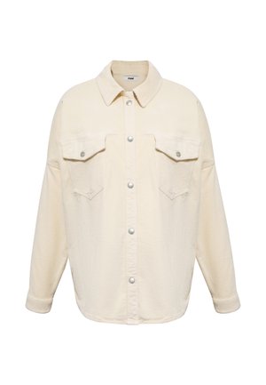 Cream corduroy shirt jacket with a pointed collar, two chest pockets, snap button closure, and relaxed fit. Textured fabric with vertical ridges.