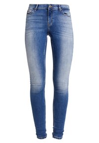 Slim fit jeans i ljusblå denim, med blekta områden och lätt slitningar, med en klassisk femfickorsdesign och dragkedja fram.