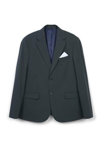 Giacca su misura verde scuro con rever a rondine, due tasche anteriori e un fazzoletto bianco nel taschino. Tessuto liscio e chiusura a un bottone.