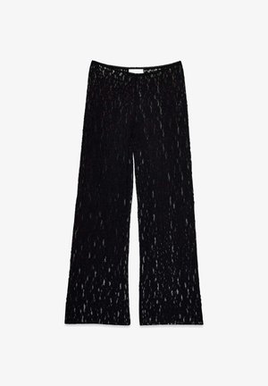 Schwarze, weite Hosen aus Spitze mit einer transparenten Textur und einem subtilen Muster. Elastischer Bund für Flexibilität und Komfort.