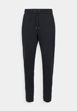 Pantaloni jogger neri in cotone con vita elastica, lacci e gamba affusolata, dotati di tasche laterali. Presentano un discreto logo.