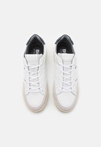 White leather sneakers with grey suede accents, round toe,  laced front, textile lining, and rubber sole. Brand logo on tongue and side.