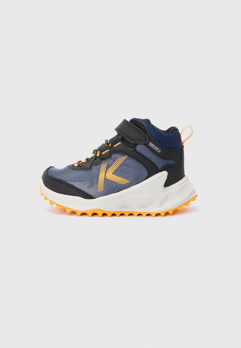 Blue and black athletic shoe with orange accents, featuring a textured upper, hook-and-loop strap, and a rugged white sole with traction spikes.