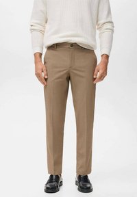 Brown tailored trousers in a smooth fabric with a straight leg design, featuring a front pocket and a subtle crease down each leg.