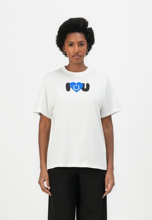 White cotton t-shirt with short sleeves featuring a graphic print of a blue heart and the text "I ❤️ U" in black. Simple round neck design.