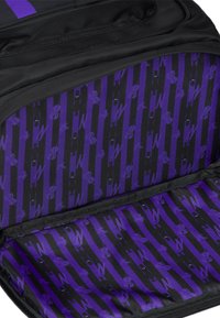 Interno di uno zaino nero con un motivo a strisce viola e dettagli grafici. Texture liscia con chiusura a zip per un facile accesso.