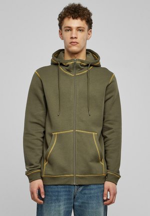 Hooded zip-up sweatshirt in olive green, featuring yellow stitching, two front pockets, and a drawstring hood. Soft, textured fabric.