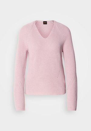 Light pink knitted sweater with a V-neck, long sleeves, and subtle textured details on the sleeves and sides. Features a logo on the hem.