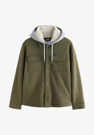 Giacca verde oliva con superficie strutturata, due tasche sul petto e cappuccio foderato in sherpa grigio. Presenta bottoni a pressione e polsini a coste.