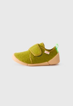 Green toddler shoe with tan sole, velcro strap, green heel loop, and small red "superfit" label on side.