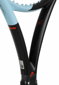 Tennis racket with lightweight black frame and blue grip. Features a barcode sticker and red accent branding near the throat.