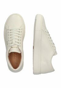 White leather sneakers with round toe, lace-up design, textured rubber sole, and subtle branding on the side. Smooth finish overall.