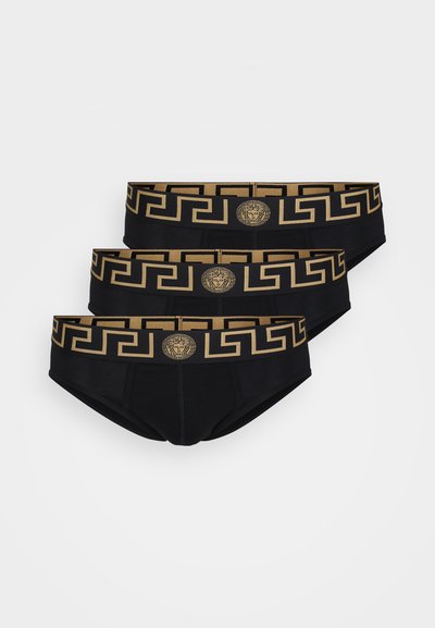 Boxeri scurți din bumbac negru cu un brâu cu un model geometric aurie și detalii cu logo. Trei perechi sunt aranjate una peste alta, evidențiind consistența designului.