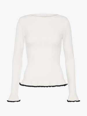 White long-sleeve fitted top with boat neckline, featuring black ruffled trim at hem and cuffs.