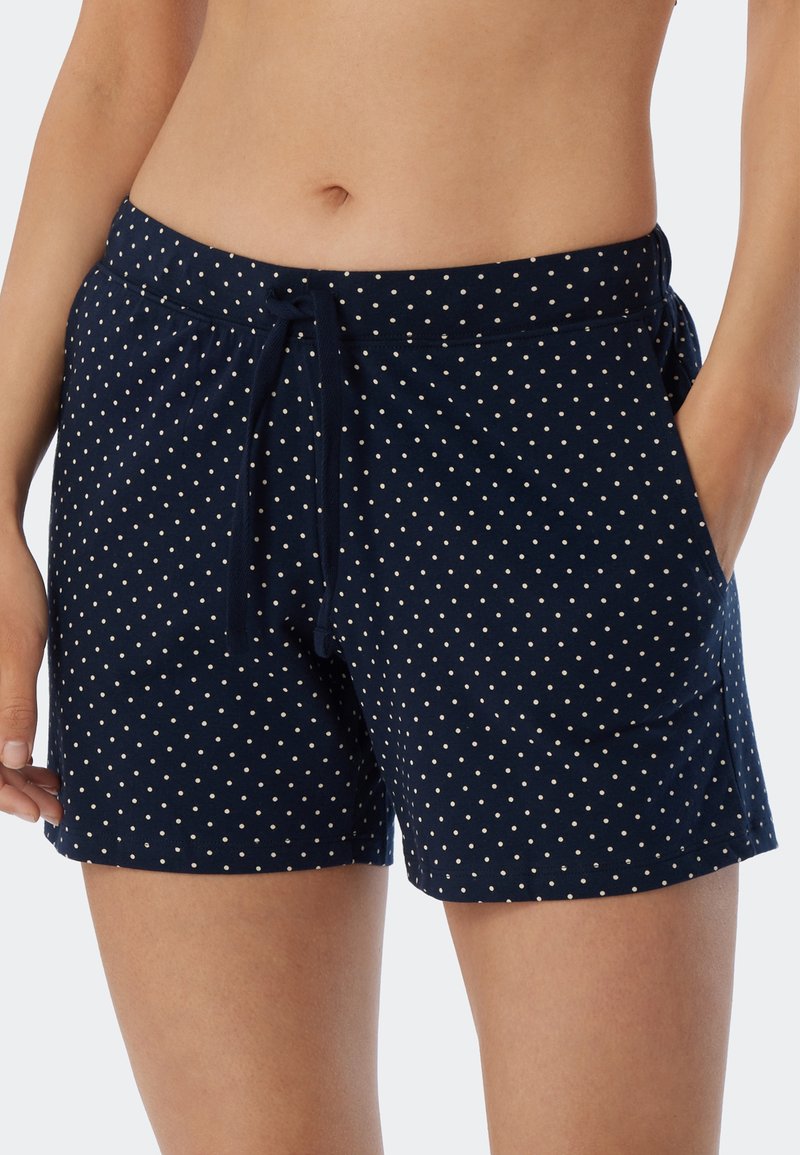 Mörkblå shorts i mjukt tyg med dragsko i midjan och vita prickar, utrustade med sidofickor och en avslappnad passform.