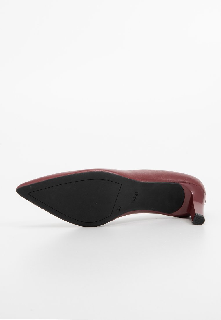Scarpa con tacco alto color bordeaux con punta affilata, materiale superiore liscio e suola nera elegante, con un'altezza del tacco modesta.